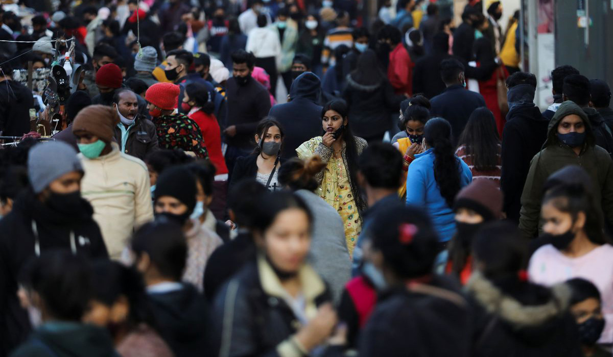 People shop at a market in New Delhi